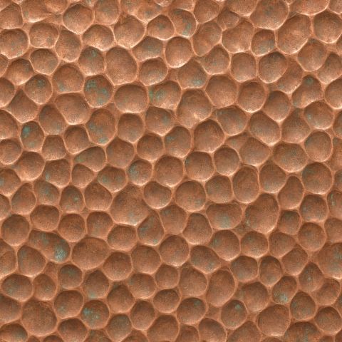 Hammered copper swatch with a dimpled, verdigris-flecked surface